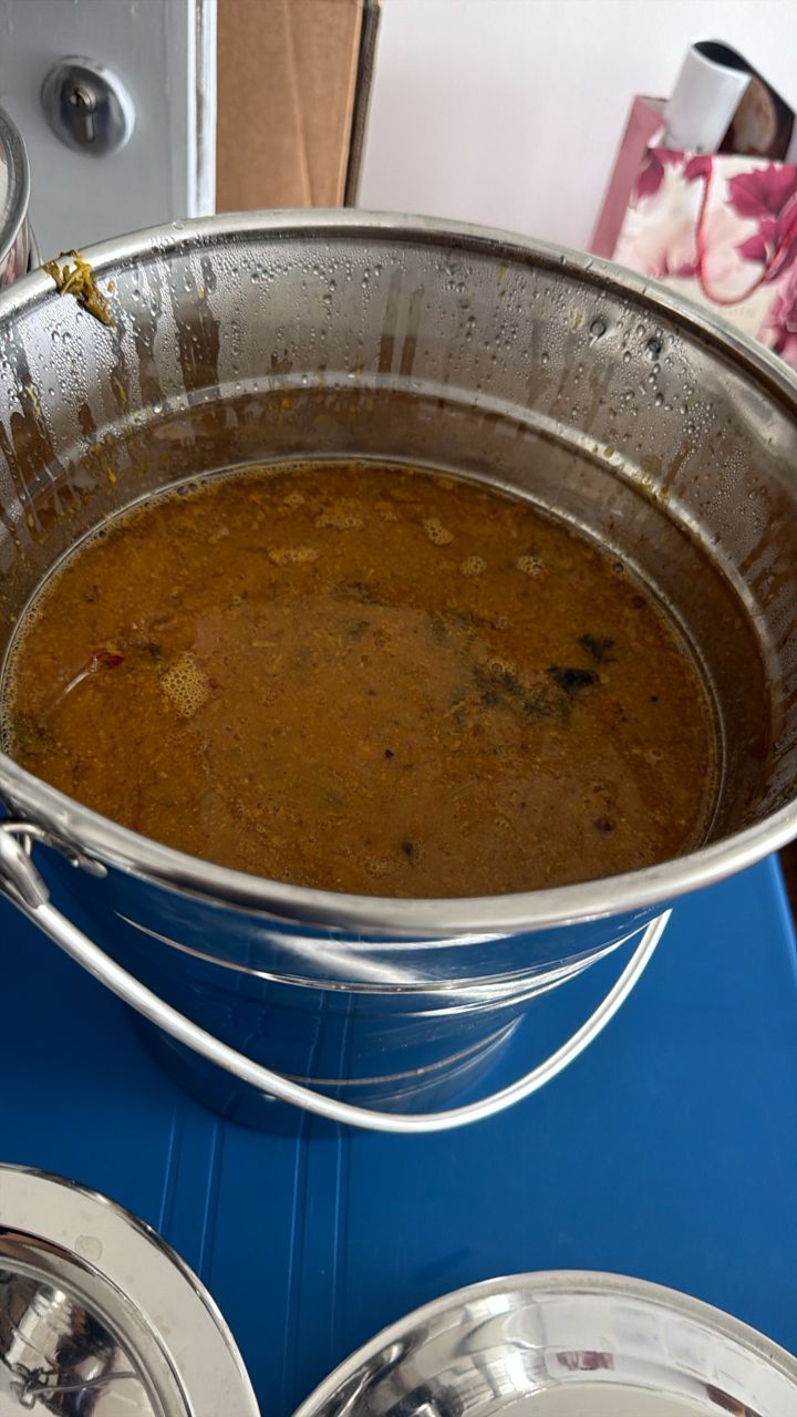 A warming pot of Chennai-style sambar