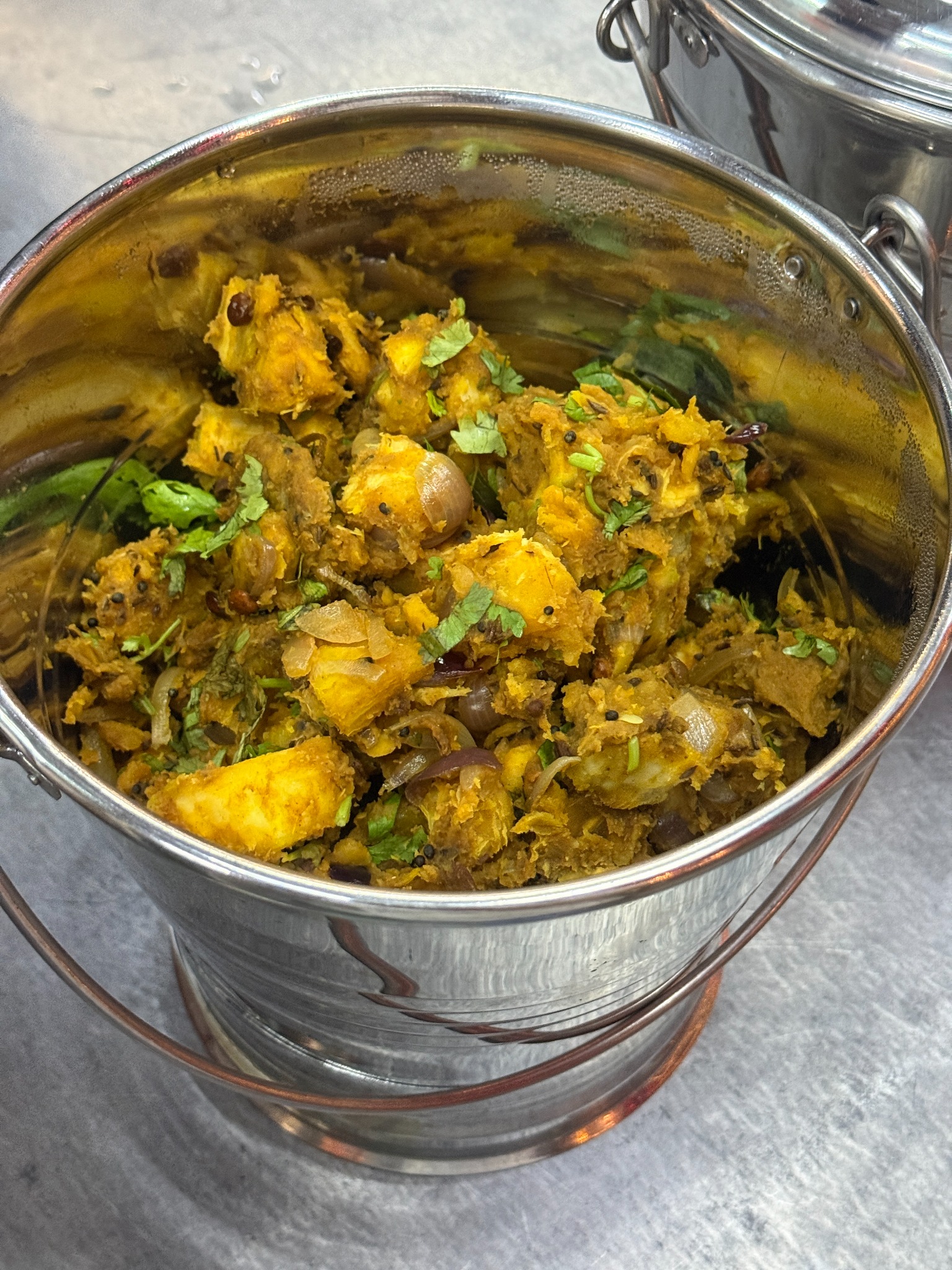 Spiced tapioca varuval garnished with fresh herbs